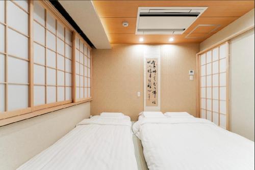 a row of beds in a room with windows at Sunlight Room3-2 in Tokyo