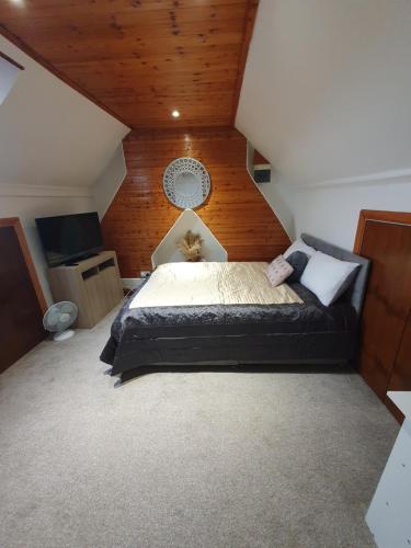 a bedroom with a large bed in a attic at Private Double Room in Cardiff in Cardiff