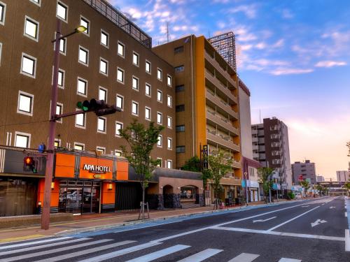 an empty city street with buildings and a traffic light at APA Hotel Saga Ekimae Chuo in Saga