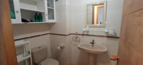 a small bathroom with a sink and a toilet at Tramuntana Beach in Calafell