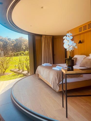 a bedroom with a bed and a table with flowers on it at Domaine de Chabrague in Amou