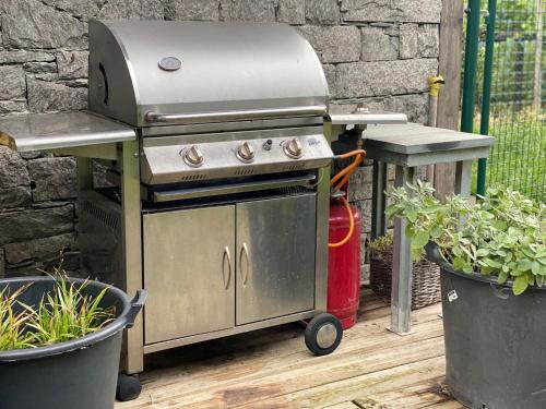 an outdoor grill with a grill at casa vacanze LA CA Del Cunfec in Sondrio