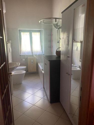 a bathroom with a sink and a toilet and a sink at casa vacanze LA CA Del Cunfec in Sondrio