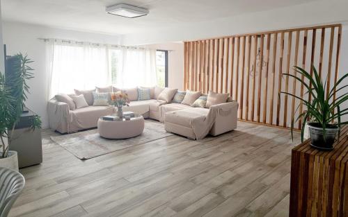 a living room with a couch and a table at Villa JULIE, Plages de Belle Mare à 10 minutes in Post of Flacq