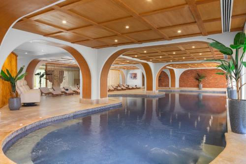 a swimming pool in a hotel lobby with a large indoor pool at Pickalbatros Aqua Blu Sharm El Sheikh in Sharm El Sheikh