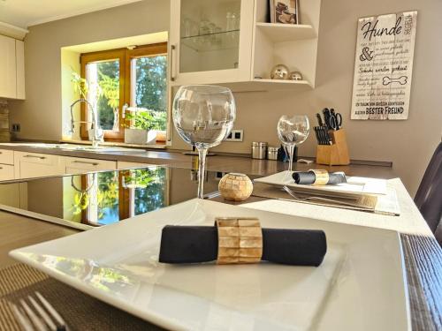 a kitchen with a table with two wine glasses on it at NEU! Design-Landhaus in Raeren-Natur, Ruhe & Stil in Raeren