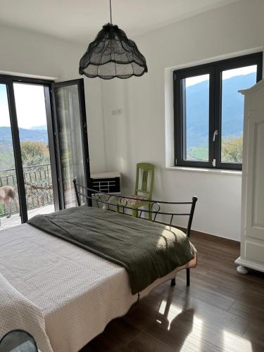 a bedroom with a bed and a large window at La Rosa di Tempalta in Roccadaspide