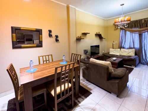 a living room with a table and a couch at Cozy Townhouse, with back yard (98) in Sheikh Zayed