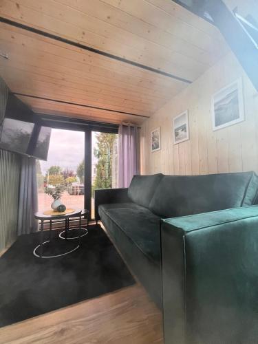 a living room with a couch and a table at tiny house Eisingen in Eisingen