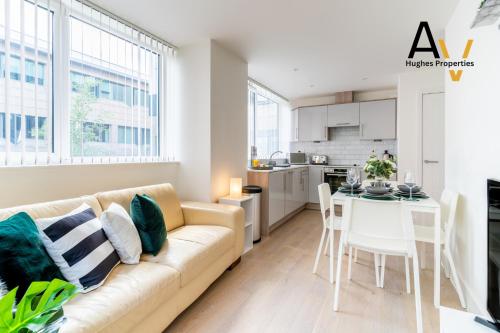 a living room with a couch and a table at Luxury Two-Bedroom Apartment - Free Wi-Fi, Close to Station, Ideal for Relocation Guests by AV Hughes Properties in Milton Keynes