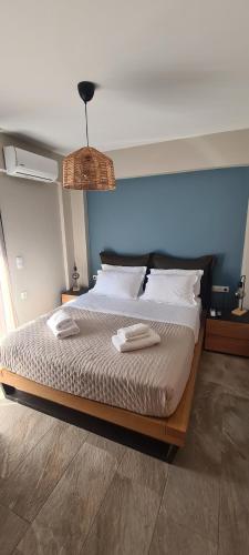 una camera da letto con un letto con due asciugamani sopra di Theros a Nikiana