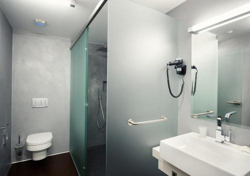 a bathroom with a shower and a sink and a toilet at Beachwell in Pelhřimov