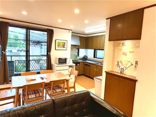 a kitchen and living room with a table and chairs at TSURUNOYA Entire House Tatami Shoji , 8 minutes walk from station free Parking new open Asakusa Akihabara Tokyo sky tree Disneyland nearby 110m2 in Tokyo