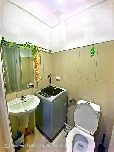 a small bathroom with a toilet and a sink at Shell Residence Pasay City in Manila