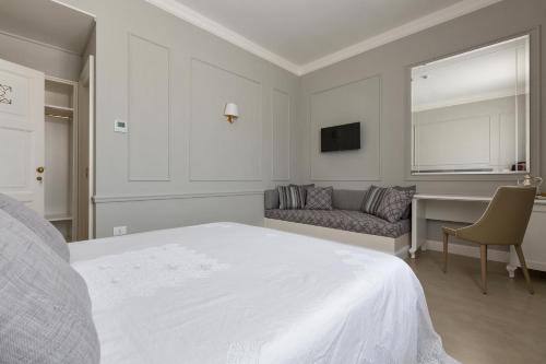 a bedroom with a bed and a couch and a desk at Palazzo Fasti in Casarano
