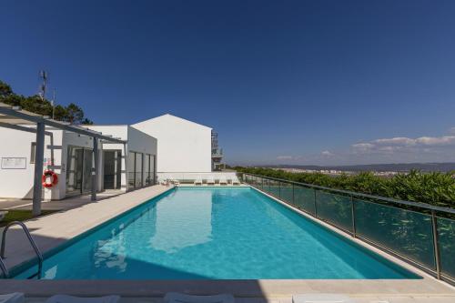a swimming pool on the roof of a house at Atlantic Panoramic Villa in Salir de Porto
