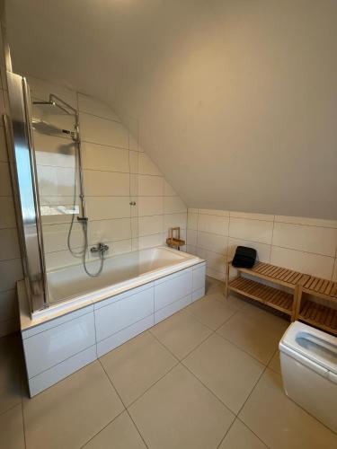 a bathroom with a shower and a tub and a toilet at Duplex appartement 'De Wijers' met 3 slaapkamers in Genk