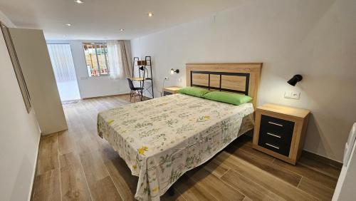 a bedroom with a bed and a wooden floor at Modern Duplex Studio with BBQ in Molnás