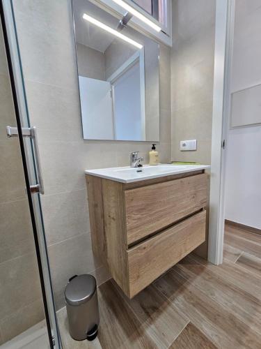 a bathroom with a sink and a mirror at Modern Duplex Studio with BBQ in Molnás