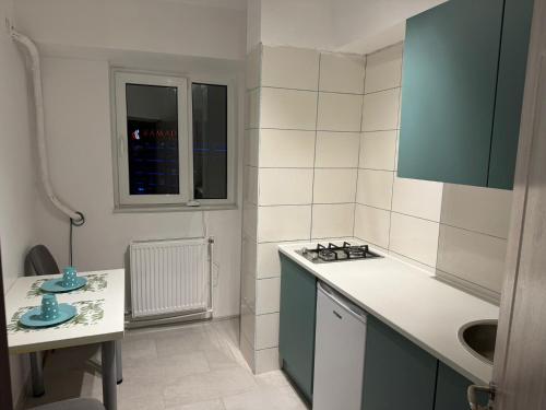 a kitchen with a sink and a counter top at Garsoniera centru in Craiova