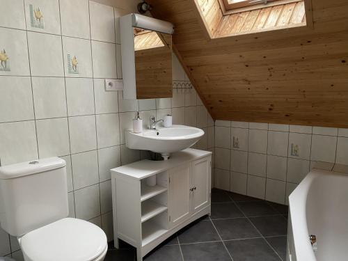 a bathroom with a white toilet and a sink at Pension Harmony in Liptovský Michal