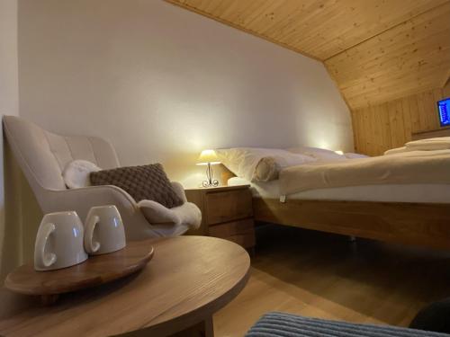 a hotel room with two beds and a table and a table sidx sidx at Pension Harmony in Liptovský Michal