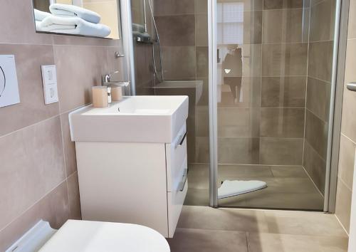 a bathroom with a shower and a toilet and a sink at Haus Nordland in Juist