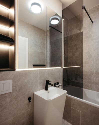 a bathroom with a sink and a shower at Campus - Palas Moonlight in Iaşi
