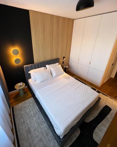 a bedroom with a large white bed in a room at Campus - Palas Moonlight in Iaşi
