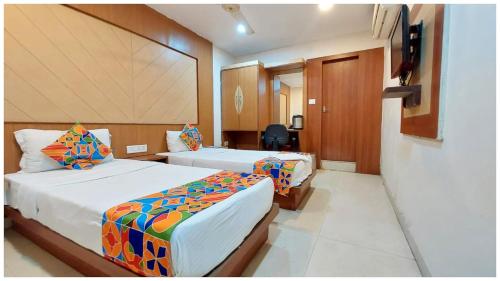a hotel room with two beds and a mirror at Hotel Park-Resort Bhubaneshwar Near Railway Station - A Premium Hotel Lift Facilites And Parking ,wifi - Fully Air Conditioning Luxury Room in Cuttack