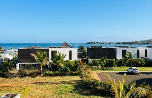 a view of a house with the ocean in the background at Asmara Mauritius Oceanfront Retreat in Petite Case Noyale