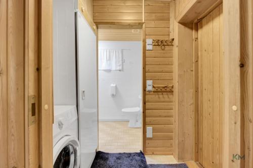 a bathroom with a washer and dryer in a house at Villa Aurora - Valkea Homes in Pelkosenniemi