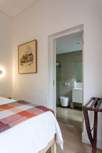 a bedroom with a bed and a bathroom at Minserie Collection in Stellenbosch