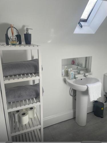 a white bathroom with a sink and a sink at Flat 2 Meadow view in Hurst