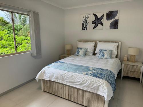 ein Schlafzimmer mit einem Bett und einem Fenster in der Unterkunft Coral Oasis - Cairns - Holloways Beach in Holloways Beach