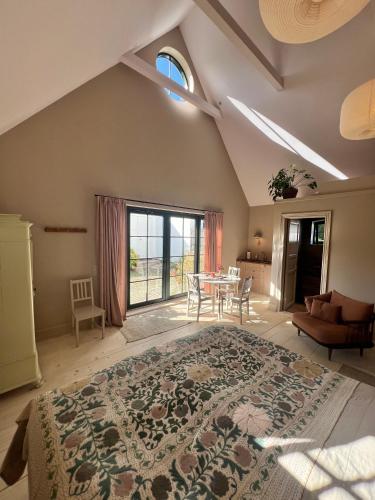 a bedroom with a large bed and a table at Luxury Guesthouse, 30 min from Copenhagen in Stenløse