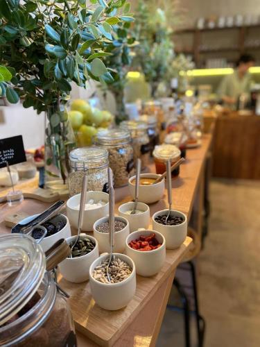 a long table filled with bowls of seeds and vegetables at Azenhas do Mar Valley House in Sintra