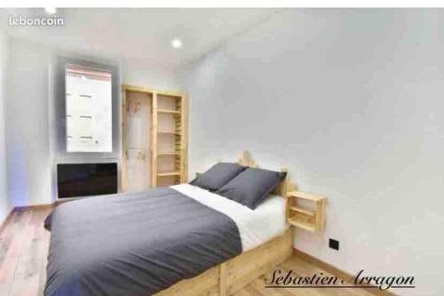 a bedroom with a large bed in a white room at Village house in Penne-dʼAgenais