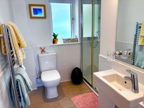 a bathroom with a toilet and a sink and a shower at Sunsets, Sandylands Prom Morecambe in Morecambe