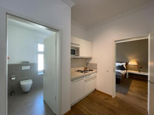 Postel nebo postele na pokoji v ubytování Haven Hotels - Helvetia Suites Düsseldorf City