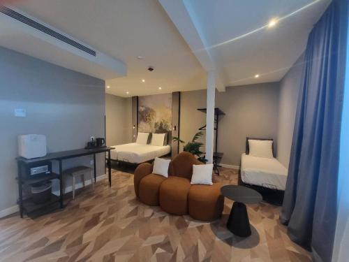 a living room with a couch and two beds at Nebula Hotel by Ine's in Assendelft