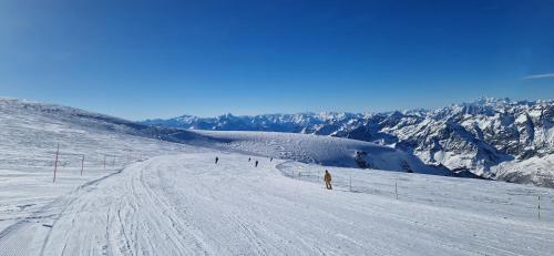 a group of people skiing down a snow covered slope at Chalet Sandgrube in Mörel