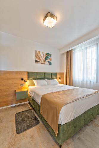 a bedroom with a large bed in a room at Villa Di Montagna wellness & spa in Zlatibor
