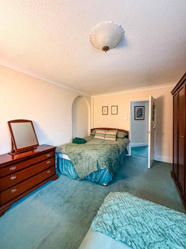 a bedroom with two beds and a dresser at Watchfield Highbridge in Highbridge