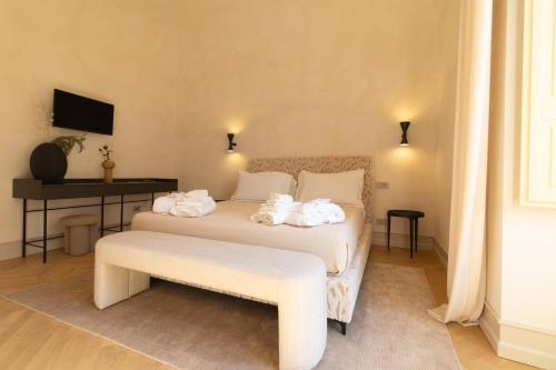 a bedroom with a bed with towels on it at Palazzo Balsamo Boutique Hotel in Palermo