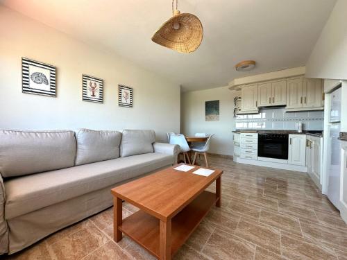 a living room with a couch and a table at Apartamento Balea - San Vicente do Mar in Balea
