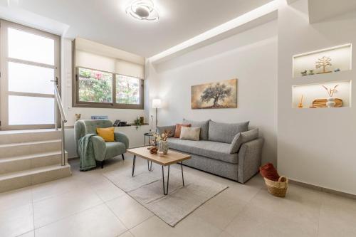 a living room with a couch and a table at Manelia, ground floor, central apartment in Bendevís