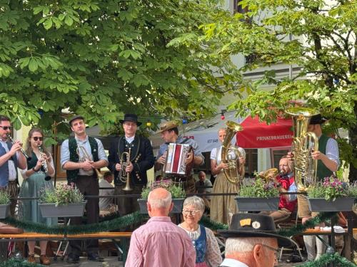 Brauereigasthof Falter في ريغين: مجموعة من الأشخاص يعزفون على الآلات النحاسية في الحديقة