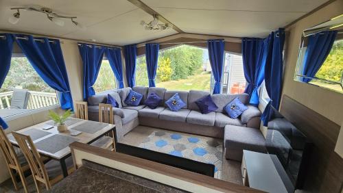 a living room with a couch and a table at Great Yarmouth PK Sunset View - NOW with Linen in Great Yarmouth