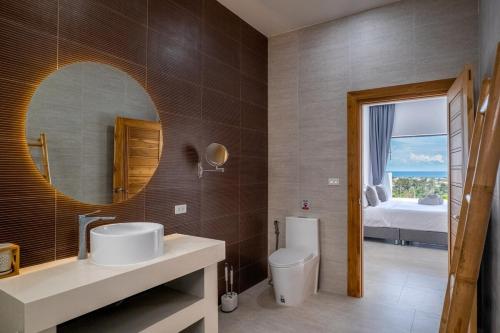 a bathroom with a sink and a mirror at Villa Orchidée Infinity pool & sea view 3BR in Amphoe Koh Samui